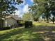 Spacious backyard with mature trees and lush grass, providing a serene outdoor setting at 3002 Sail Pointe Cir # 1B, Venice, FL 34293