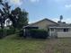 Manicured backyard features mature shrubs, well-maintained lawn, and a screened-in porch at 3002 Sail Pointe Cir # 1B, Venice, FL 34293