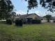 Well-maintained backyard featuring lush green grass and trimmed hedges enhancing outdoor appeal at 3002 Sail Pointe Cir # 1B, Venice, FL 34293