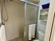 Bathroom featuring a tile shower with sliding glass doors at 3002 Sail Pointe Cir # 1B, Venice, FL 34293