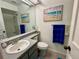 Bathroom with gray countertop, beach-themed decor, and toilet at 3002 Sail Pointe Cir # 1B, Venice, FL 34293