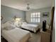 Bright guest bedroom with twin beds, plantation shutters, and comfortable furnishings at 3002 Sail Pointe Cir # 1B, Venice, FL 34293