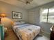 Comfortable bedroom with a ceiling fan, closet, and natural light at 3002 Sail Pointe Cir # 1B, Venice, FL 34293