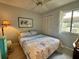 Bedroom featuring a cozy bed, ceiling fan, and shuttered window for natural light at 3002 Sail Pointe Cir # 1B, Venice, FL 34293