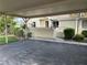Residential property featuring a covered carport and walkway leading to the entrance at 3002 Sail Pointe Cir # 1B, Venice, FL 34293