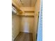 Walk-in closet with wood floor, multiple shelves, and hanging rack for storage at 3002 Sail Pointe Cir # 1B, Venice, FL 34293