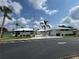 East Village Center featuring well-maintained grounds, palm trees and ample parking at 3002 Sail Pointe Cir # 1B, Venice, FL 34293