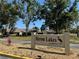 Entrance to Heron Lakes featuring a well-maintained sign and lush landscaping creating an inviting welcome at 3002 Sail Pointe Cir # 1B, Venice, FL 34293