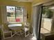 Cozy dining area with a small table, chairs, and natural light from a window at 3002 Sail Pointe Cir # 1B, Venice, FL 34293