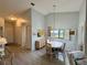 Bright dining area with vaulted ceilings adjacent to a cozy living room at 3002 Sail Pointe Cir # 1B, Venice, FL 34293