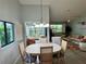 Open-concept dining room connected to living areas with a view through the house at 3002 Sail Pointe Cir # 1B, Venice, FL 34293