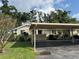 Charming single-story home featuring a covered carport and well-maintained landscaping at 3002 Sail Pointe Cir # 1B, Venice, FL 34293