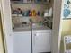 Convenient laundry closet featuring a side-by-side washer and dryer at 3002 Sail Pointe Cir # 1B, Venice, FL 34293