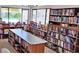 Community library featuring shelves stocked with books and ample reading space at 3002 Sail Pointe Cir # 1B, Venice, FL 34293
