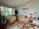 Inviting living room with light blue walls, a ceiling fan, and comfortable seating arrangement at 3002 Sail Pointe Cir # 1B, Venice, FL 34293