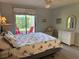 Comfortable main bedroom featuring outdoor access, bright lighting, and beach themed decor at 3002 Sail Pointe Cir # 1B, Venice, FL 34293