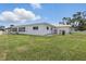 Spacious backyard featuring a white fence and lush green lawn at 3105 Gulfgate Dr, Sarasota, FL 34231