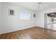 Clean and bright bedroom with wood flooring, a window, and access to the sunroom at 3105 Gulfgate Dr, Sarasota, FL 34231