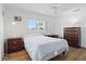 Bedroom with ceiling fan, wood-look floors, and large window at 3105 Gulfgate Dr, Sarasota, FL 34231