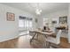 Bright dining room with modern light fixture and sliding glass door to the lanai at 3105 Gulfgate Dr, Sarasota, FL 34231