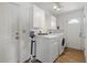 Laundry room with modern washer and dryer and built in cabinets at 3105 Gulfgate Dr, Sarasota, FL 34231