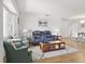Open living area with comfortable seating, wood floors, and lots of natural light at 3105 Gulfgate Dr, Sarasota, FL 34231