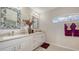 Bathroom with double sink, mirrors and a window allowing natural light at 4037 Wooley Ave, North Port, FL 34287