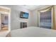 Bedroom featuring a mounted TV, neutral decor and an adjacent dressing room at 4037 Wooley Ave, North Port, FL 34287