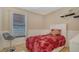 Bedroom with a bed, seat and a large window allowing natural light at 4037 Wooley Ave, North Port, FL 34287
