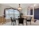 Elegant dining room with stylish glass table, modern chairs, and natural light at 4037 Wooley Ave, North Port, FL 34287