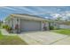 Charming single-story home featuring a spacious gray garage and well-manicured lawn at 4037 Wooley Ave, North Port, FL 34287