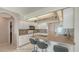 Bright kitchen featuring granite countertops, white cabinets, and stainless steel appliances at 4037 Wooley Ave, North Port, FL 34287
