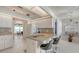 Open concept kitchen with granite countertops, an island with seating and tile flooring at 4037 Wooley Ave, North Port, FL 34287