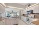 Open kitchen with granite countertops, an island with sink, and view into the Gathering room at 4037 Wooley Ave, North Port, FL 34287