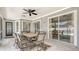 Screened lanai featuring outdoor dining set with seating and a view of the backyard at 4037 Wooley Ave, North Port, FL 34287