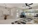 Bright living area with tile flooring, modern fan, large windows, and access to the patio at 4037 Wooley Ave, North Port, FL 34287