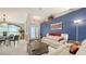 Open-concept living area with comfortable seating, decorative wall art, and seamless flow to dining at 4037 Wooley Ave, North Port, FL 34287