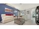 Cozy living room featuring a blue accent wall, plush seating, and stylish decor accents at 4037 Wooley Ave, North Port, FL 34287