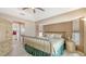 Cozy main bedroom with wood-look flooring, stylish metal bedframe and ensuite access at 4037 Wooley Ave, North Port, FL 34287