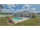 A beautiful backyard pool with patio area and screened in porch provides a serene setting at 4037 Wooley Ave, North Port, FL 34287