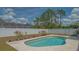 Backyard pool area surrounded by a white fence, landscaping and mature trees at 4037 Wooley Ave, North Port, FL 34287