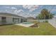 Backyard pool area surrounded by a white fence, landscaping and mature trees at 4037 Wooley Ave, North Port, FL 34287
