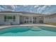 A beautiful backyard pool with patio area and screened in porch provides a serene setting at 4037 Wooley Ave, North Port, FL 34287