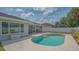 A beautiful backyard pool with patio area and screened in porch provides a serene setting at 4037 Wooley Ave, North Port, FL 34287