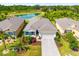 Stunning aerial view featuring lush landscaping, tranquil pond, and neighboring properties at 4119 Mossy Limb Ct, Palmetto, FL 34221