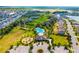Aerial view of the community pool, playground, clubhouse, and manicured landscaping at 4119 Mossy Limb Ct, Palmetto, FL 34221