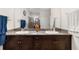 Bathroom features a double vanity with granite counters, dark cabinets, and a glass-enclosed shower at 4119 Mossy Limb Ct, Palmetto, FL 34221