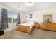 Cozy bedroom featuring a natural wood bed frame, lots of sunlight and ample space at 4119 Mossy Limb Ct, Palmetto, FL 34221