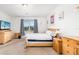 Bright bedroom showcasing natural wood furniture, white walls, and light carpet at 4119 Mossy Limb Ct, Palmetto, FL 34221