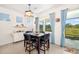 Dining room features large windows and a modern light fixture and blue curtains at 4119 Mossy Limb Ct, Palmetto, FL 34221